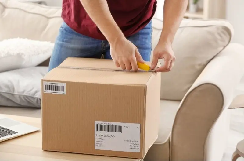 Box cutter cutting cardboard